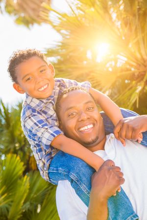 Son and Father Enjoying Outdoors Together On Sunny Day