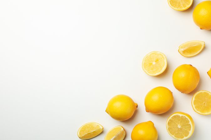 Fresh lemons on bright background, space for text. Ripe fruit