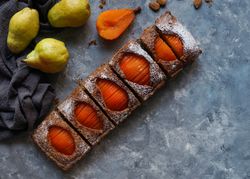 Pear cake and fruits on table