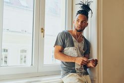 Cheerful Black male listening to music