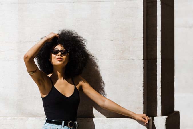 Cheerful Black female in dark sunglasses