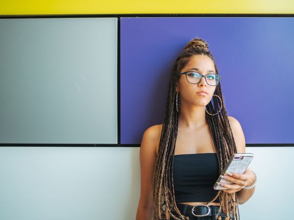 Woman with dreadlocks in glasses taking selfie
