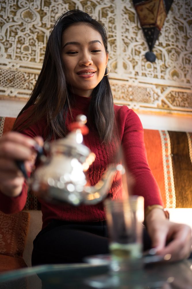 Asian woman enjoying Arabic tea