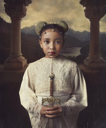 Portrait of girl in long-sleeved top holding sword