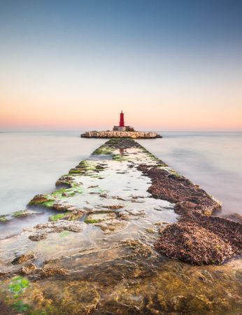Rough path to islet with lighthouse