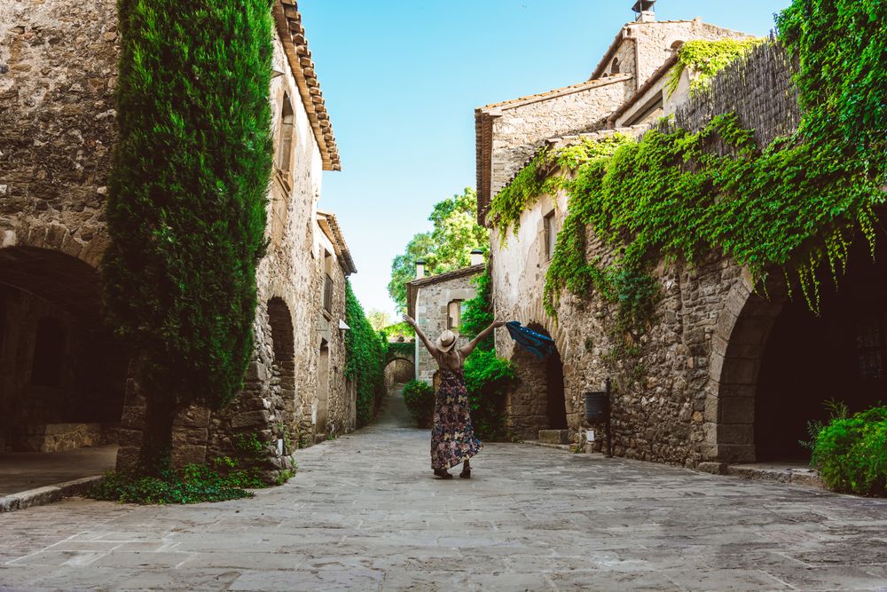 Woman walking in a narrow path in a village