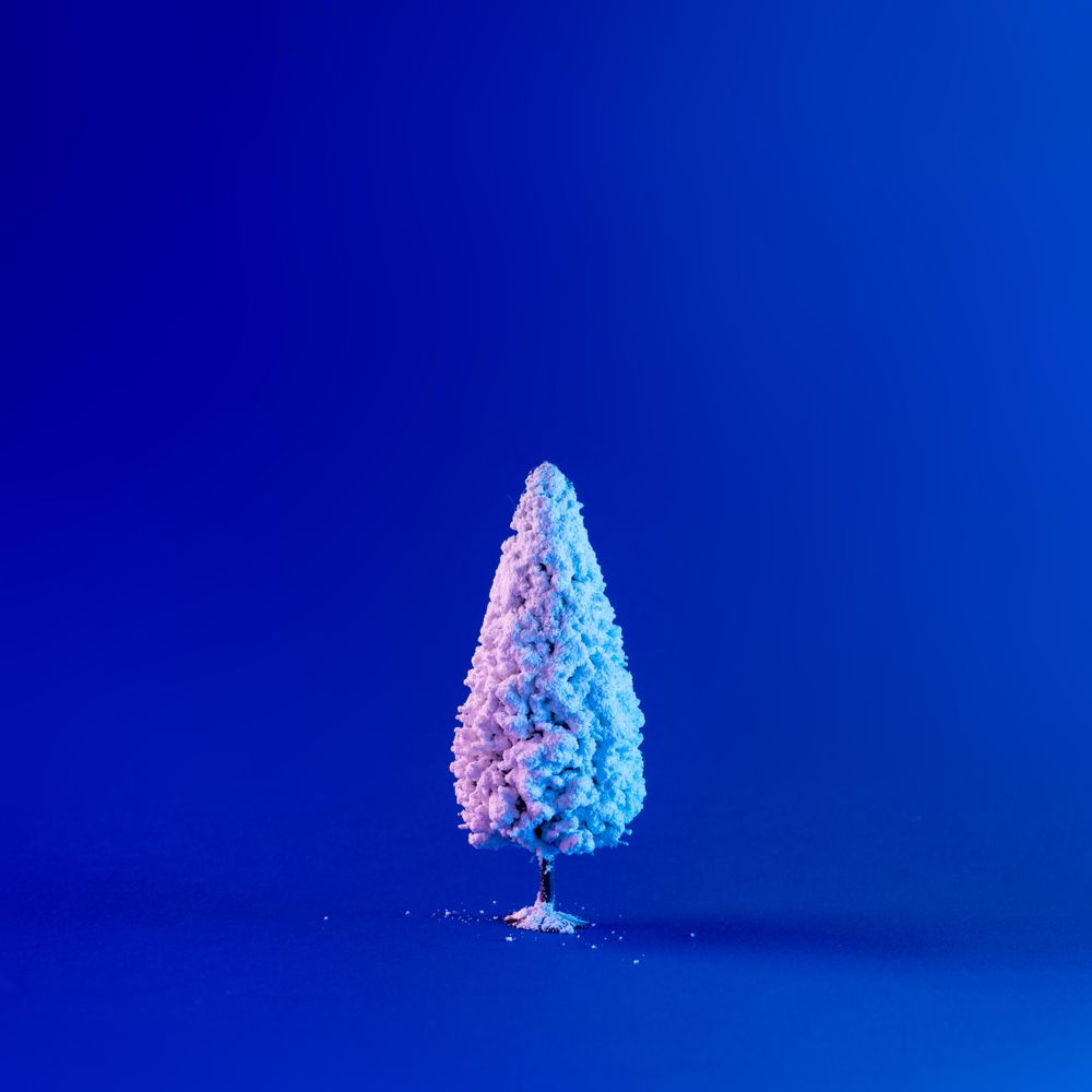 Snowy Christmas tree in vibrant bold gradient holographic colors