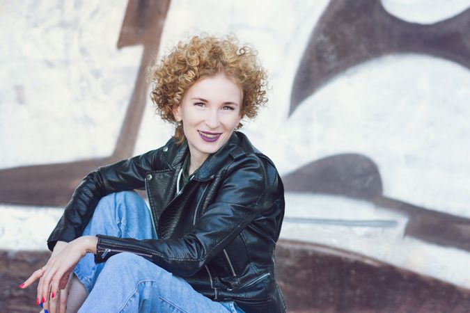 Smiling young woman with curly hairstyle