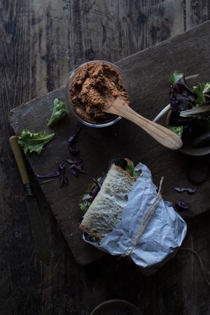 Sandwich with vegetables and dry tomatoes pate on tray