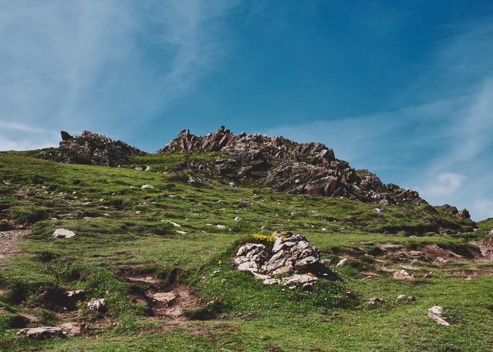 A rocky hill under a blue sky