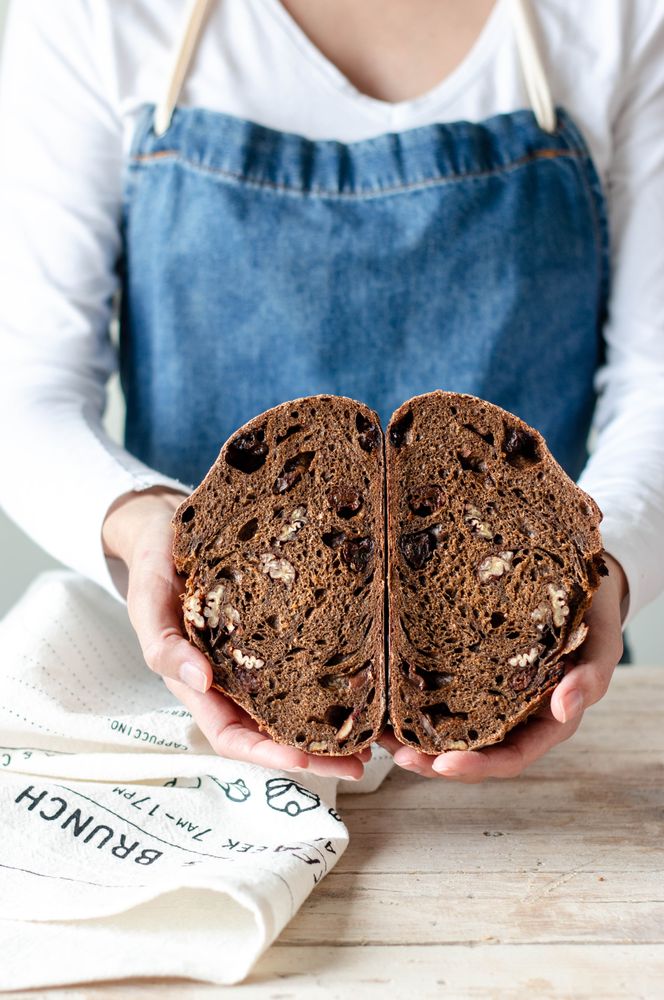 Hands of woman holding rye bread