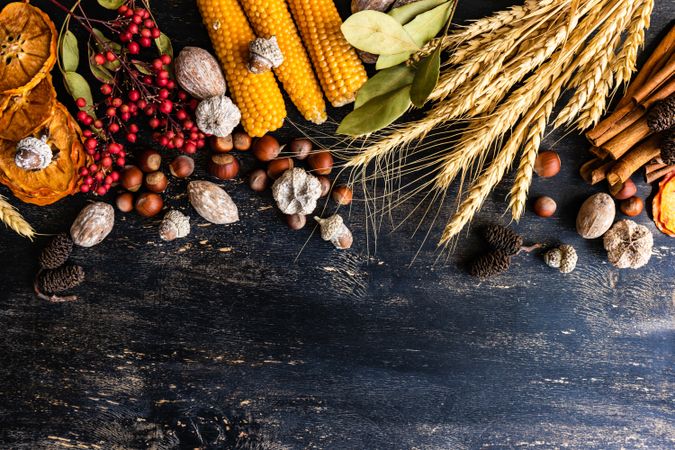 Top view of wooden table with seasonal nuts, berries, vegetable and fruits for autumn