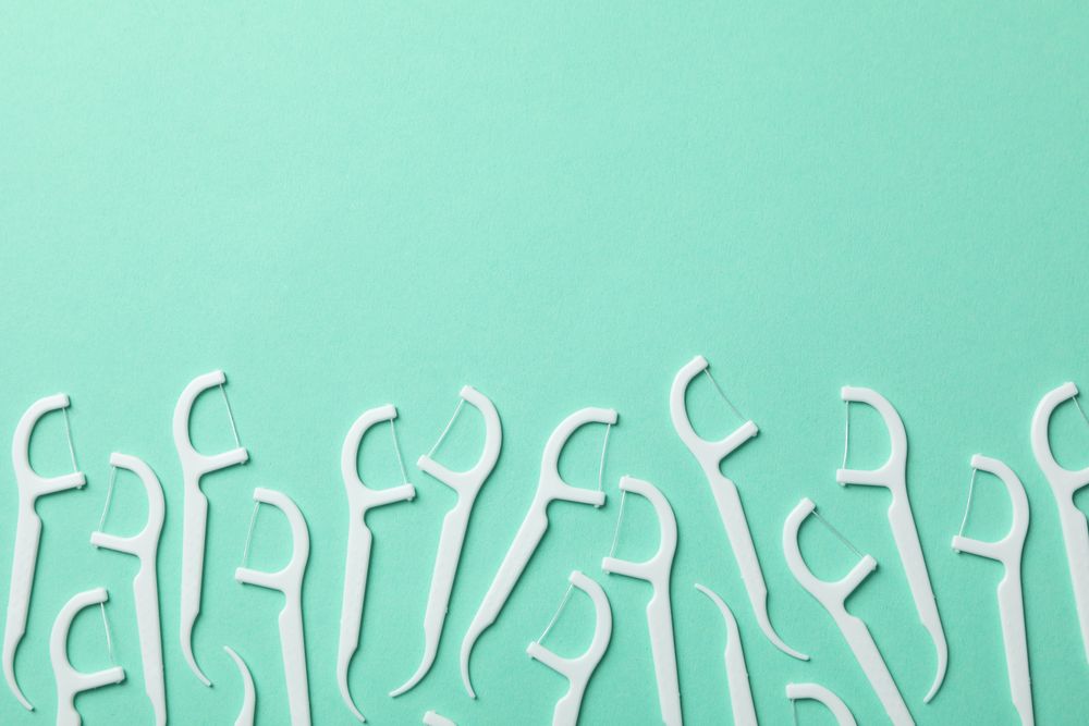 Toothpicks on mint background, space for text