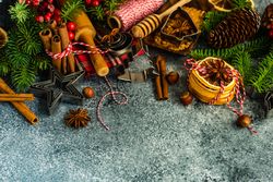 Christmas baking equipment and tree branches on concrete counter with copy space