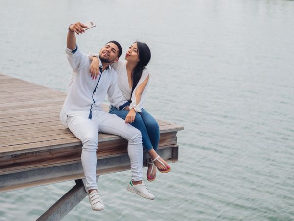 Woman with man taking photo selfie