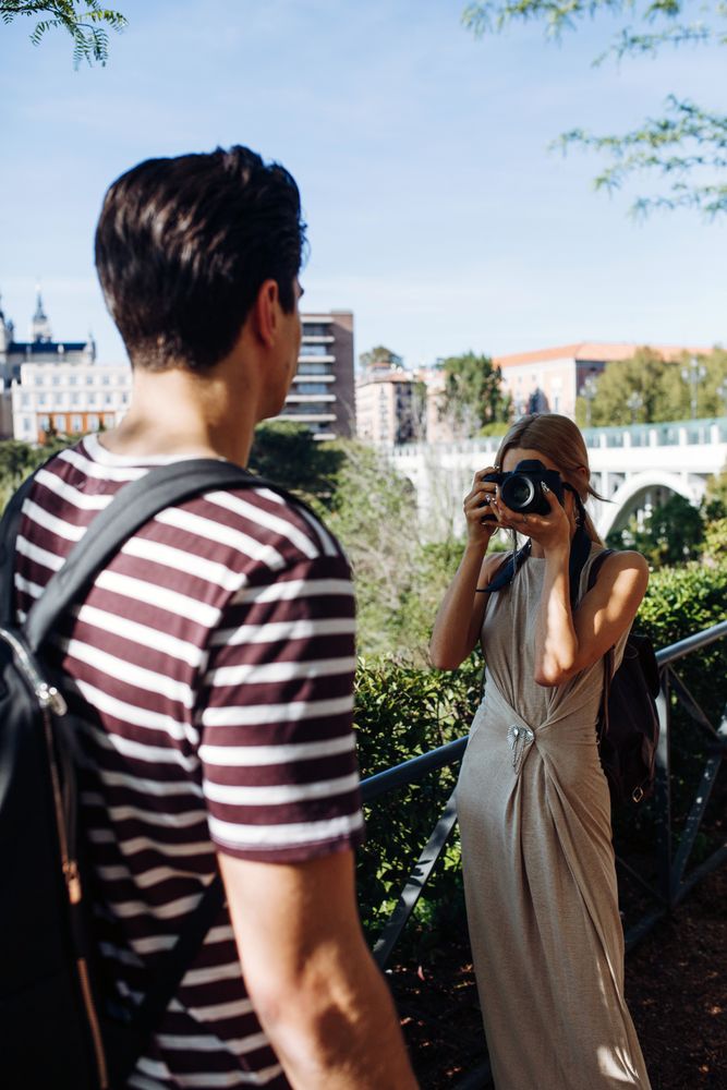 Happy young couple taking selfie in park