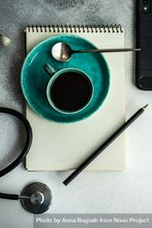 Top view of coffee cup with stethoscope, phone and notepad 4ZePv1