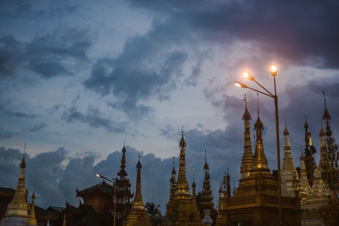Beautiful old building with towers and cloudy heaven in evening