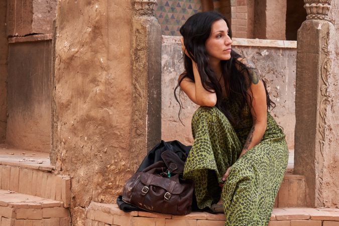 Woman on street between ancient buildings