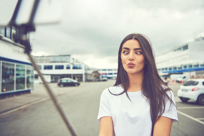 Woman crossed her eyes posing for selfie outside