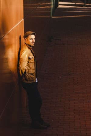 Confident guy leaning on wall