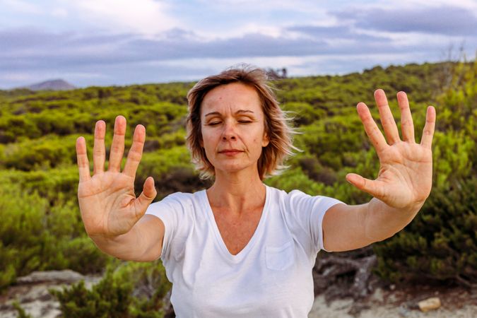 Adult woman practicing martial arts in nature