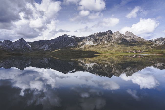 Cloudy sky over calm lake and mountains