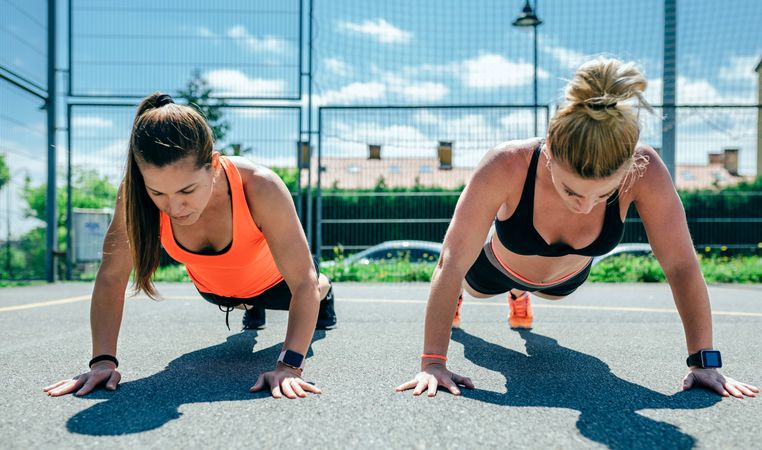 Sportswomen doing push-ups