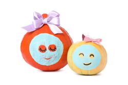 Pumpkins with facial mask and bow