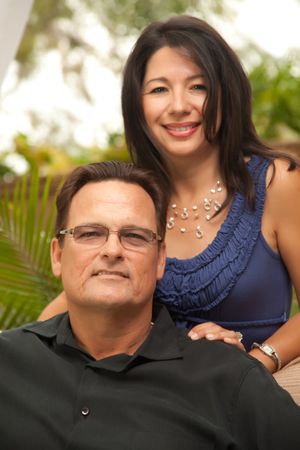 Portrait of Confident Couple In Front Of Fern