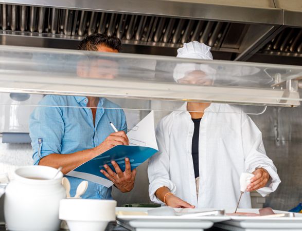 Colleagues checking food quality in canteen