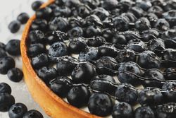 Tasty blueberry pie with syrup, close up