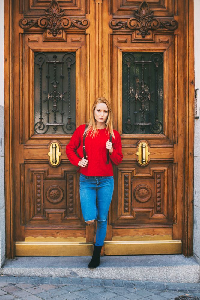 Confident woman near ornamental wall