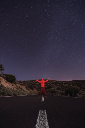 Traveler standing on empty road at night