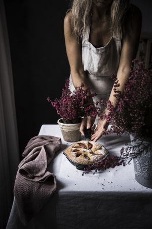 Woman cutting plum cake