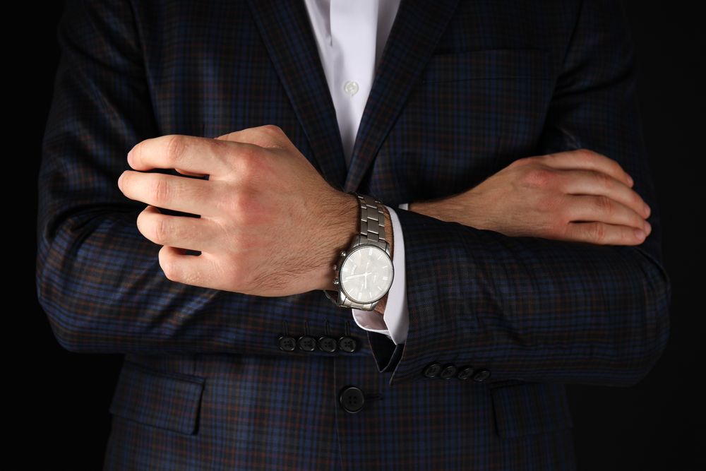 A man in a suit on a dark background