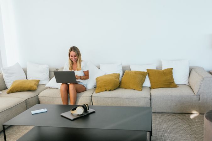 Woman browsing laptop on couch