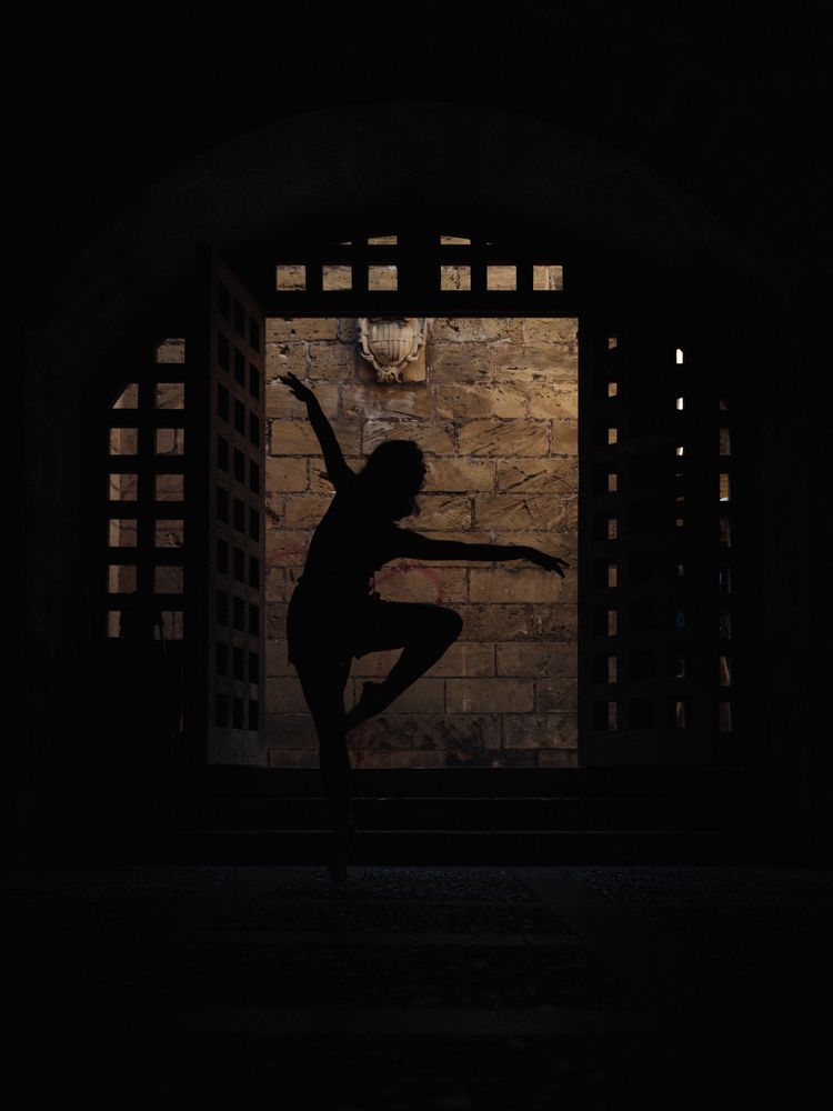 Anonymous ballet dancer in darkness