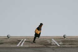 Woman balancing on street parking