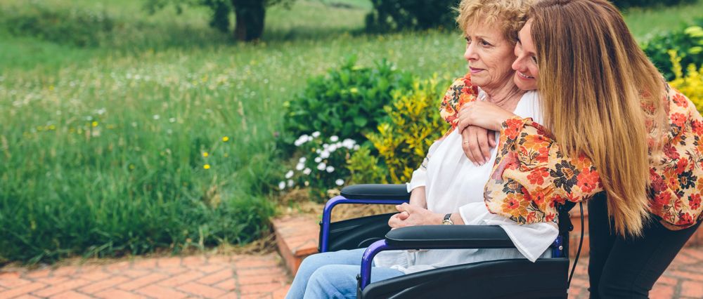 Mature woman in a wheelchair with her daughter