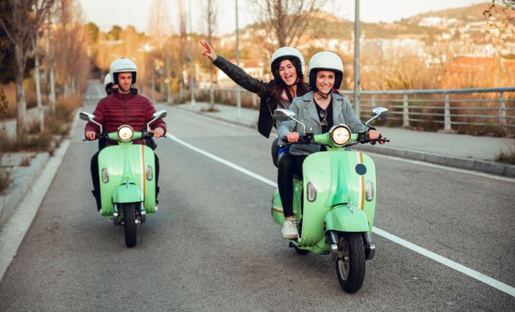 Young people riding motorcycles on city road