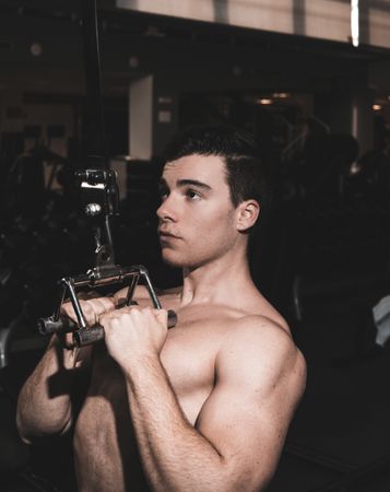 Strong guy exercising in gym