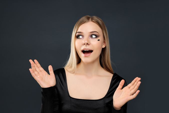 Concept of Halloween, young woman on dark background