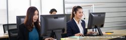 Business call center man and women with headset sitting in office desk using computer 5rXJ2b