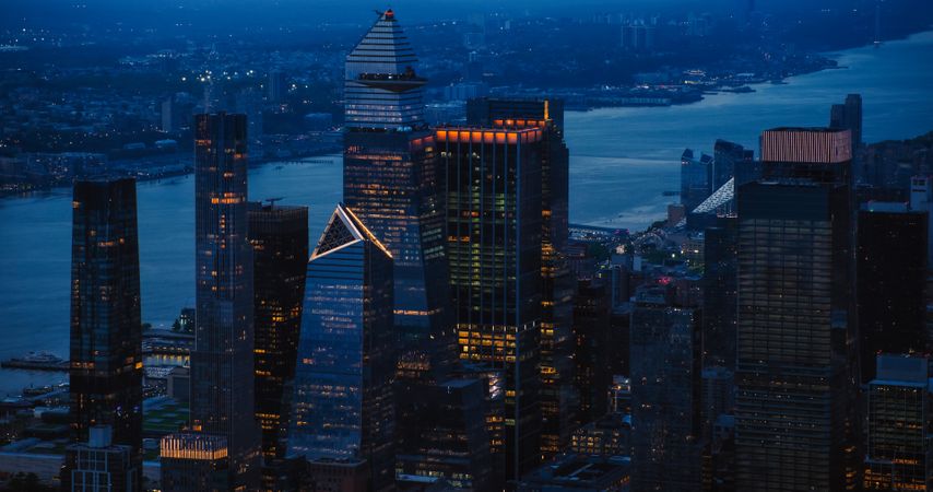 Evening Helicopter Image Above Manhattan Skyline, Focusing on 30 Hudson Yards Skyscraper with an Outside Observation Deck. Crowd of Tourists Enjoying Urban Night View From a Viewing Platform