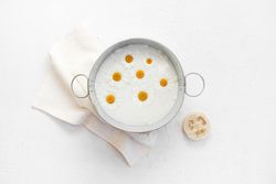 Top view of chamomile milk for at-home spa treatment