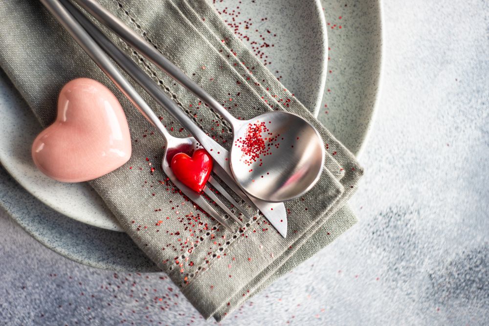Grey themed table setting for Valentine's day with pink and red heart