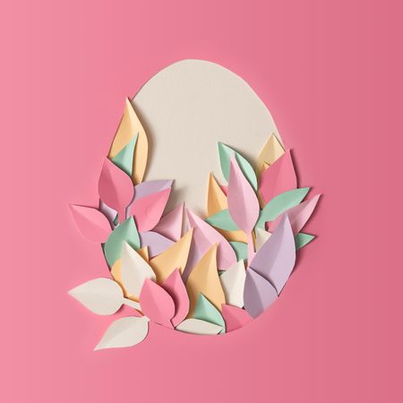 Easter layout with paper leaves in egg shape on light paper background