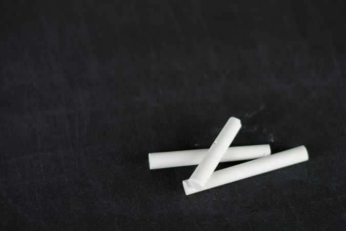 Minimalist Abstract Chalk Sticks on Dark Surface
