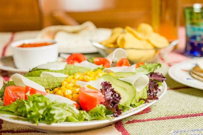 Traditional mexican food with nachos and salad